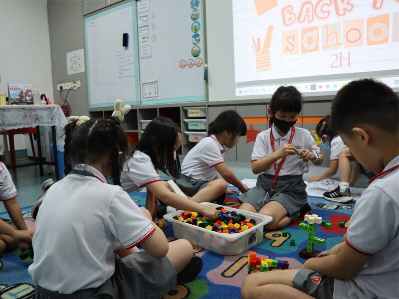 A few Year 2 students playing with some building blocks before lesson starts.