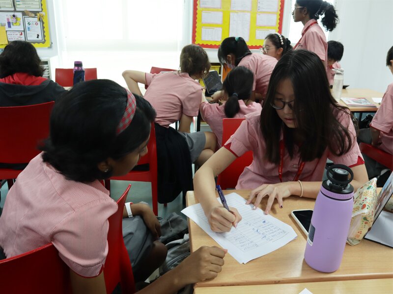 2 Secondary students filling up forms
