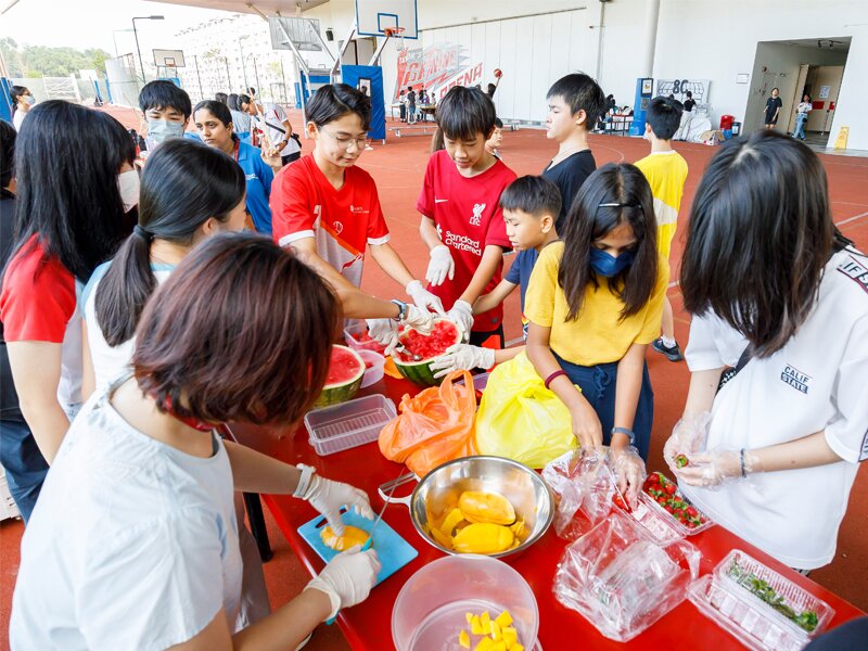 Students preparing fruits during the carnival