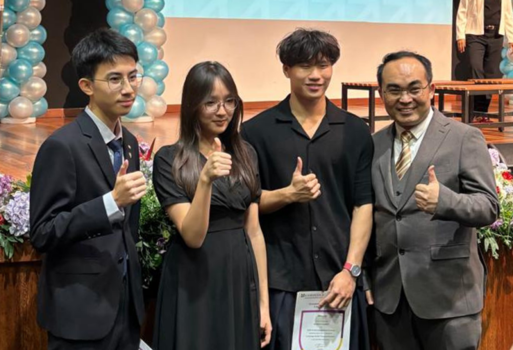 Head of Mathematics, Mr Albert, standing proudly with Taylor’s International School Puchong award recipients Eliam, Vianne, and Benjamin holding their Cambridge certificates.