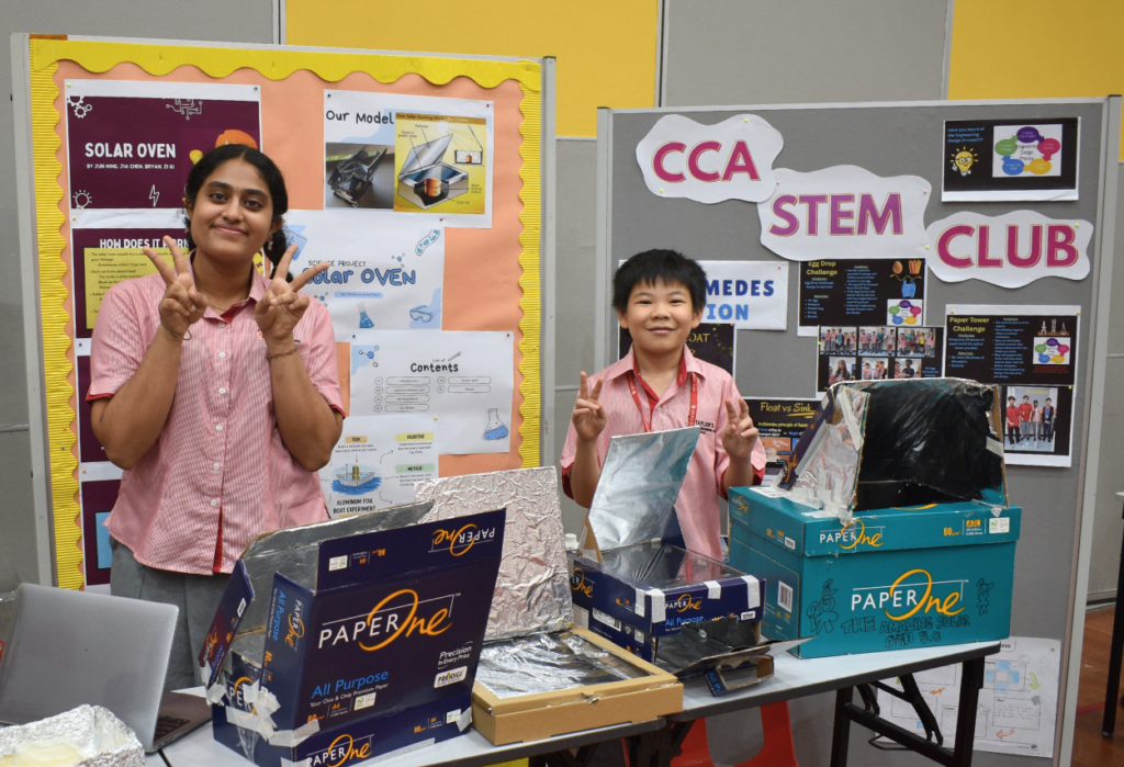 Students display solar oven and paper recycling projects at Taylor's International School Puchong STEAM Fair.