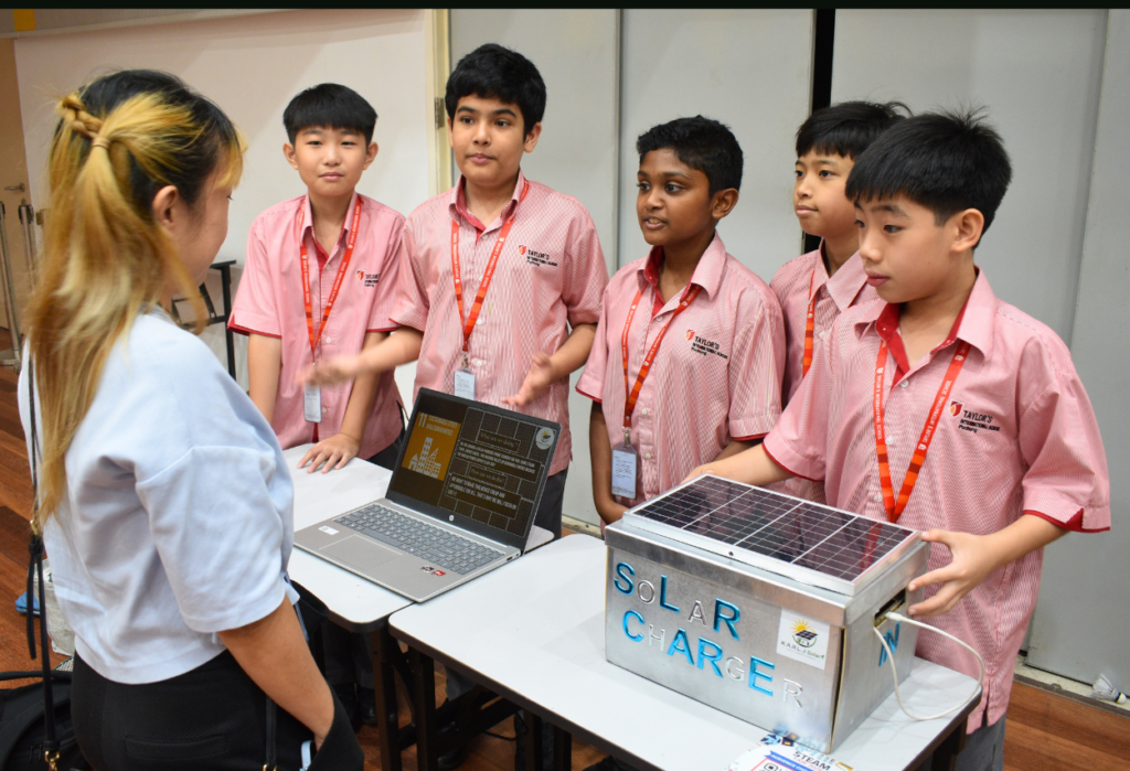 Students present a solar-powered charger project at Taylor's International School Puchong Secondary STEAM Fair.