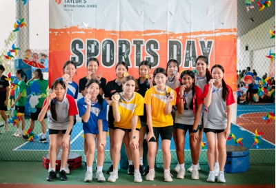 Gold, silver and bronze relay medallists pose for a group photo after the relay race at Sports Day at Taylor's International School Puchong. Yelyzaveta stands at the centre of the group.