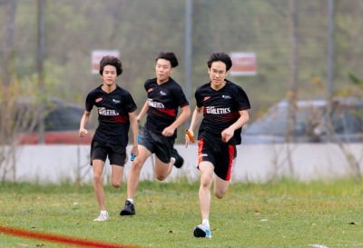 Coulson (right) runs the final leg of the relay race during Sports Day at Taylor's International School Puchong, sprinting towards the finish line as his teammates compete alongside him.