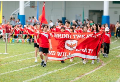 Students lead the Sports Day march-past with their House banner at Taylor's International School Puchong.