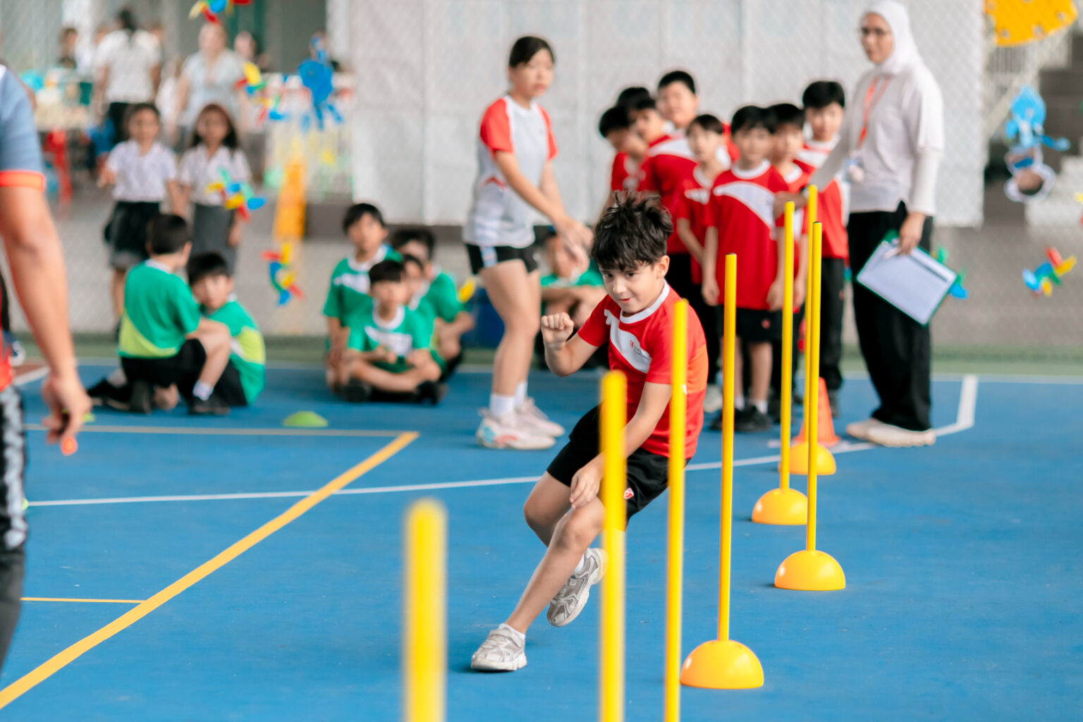 A student navigates an obstacle course during Sports Day at Taylor's International School Puchong, developing agility, coordination and confidence while classmates cheer from the sidelines.